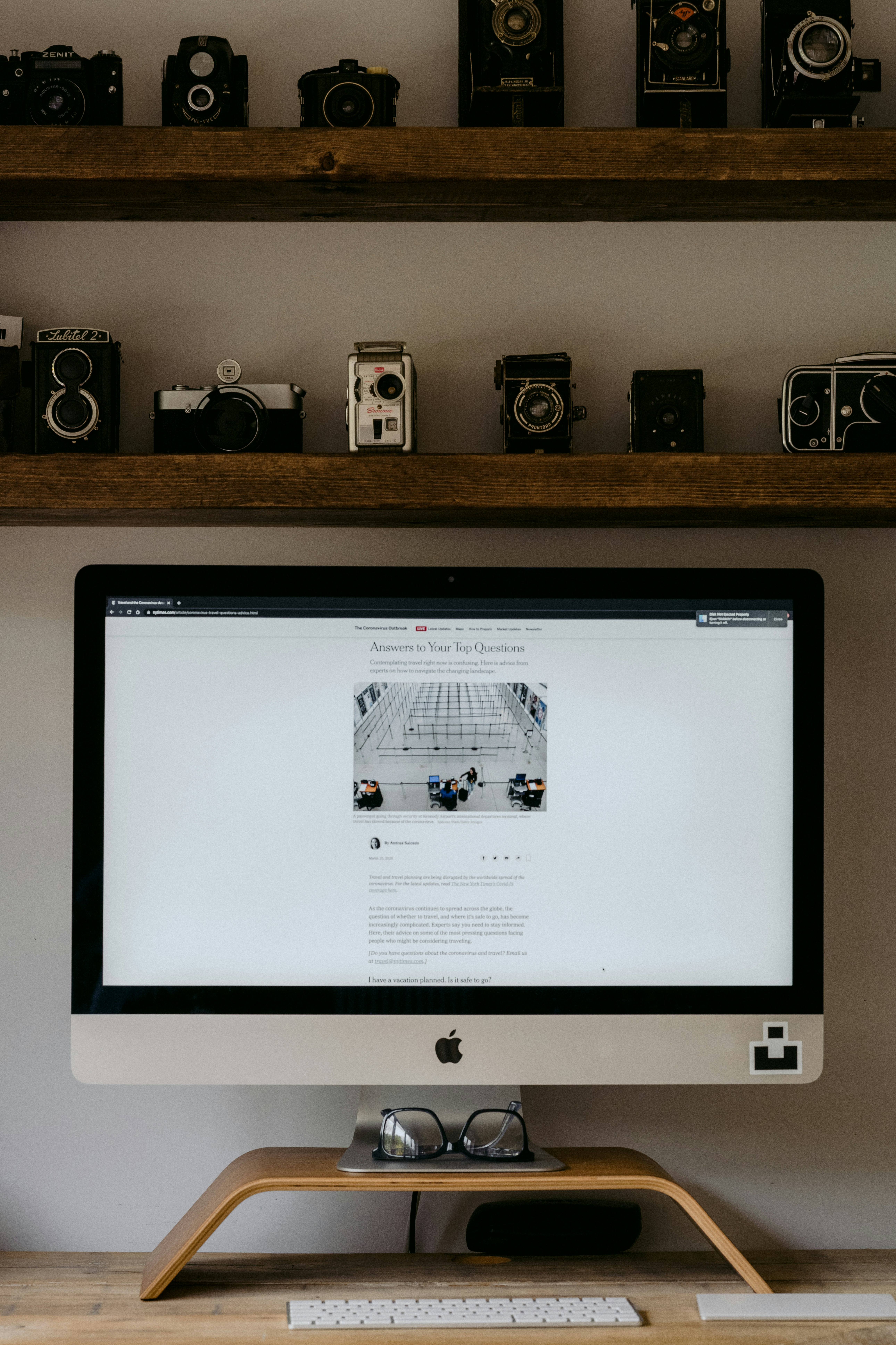 silver imac on brown wooden table